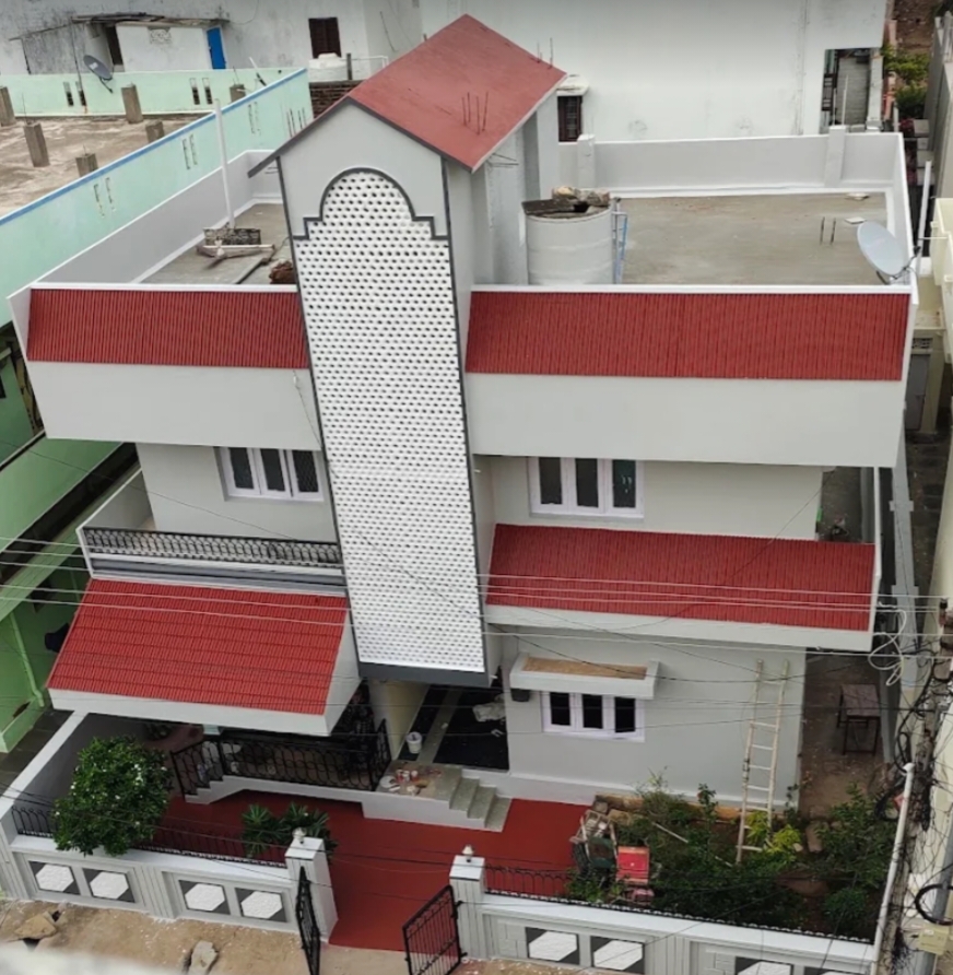 White house with red roof and red exterior accents