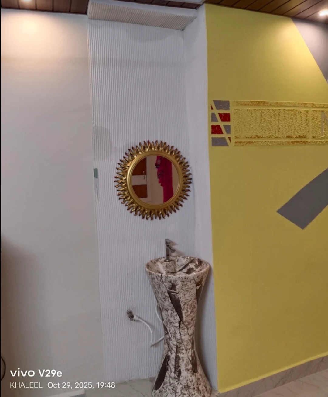 Yellow and white interior wall finishing with decorative details