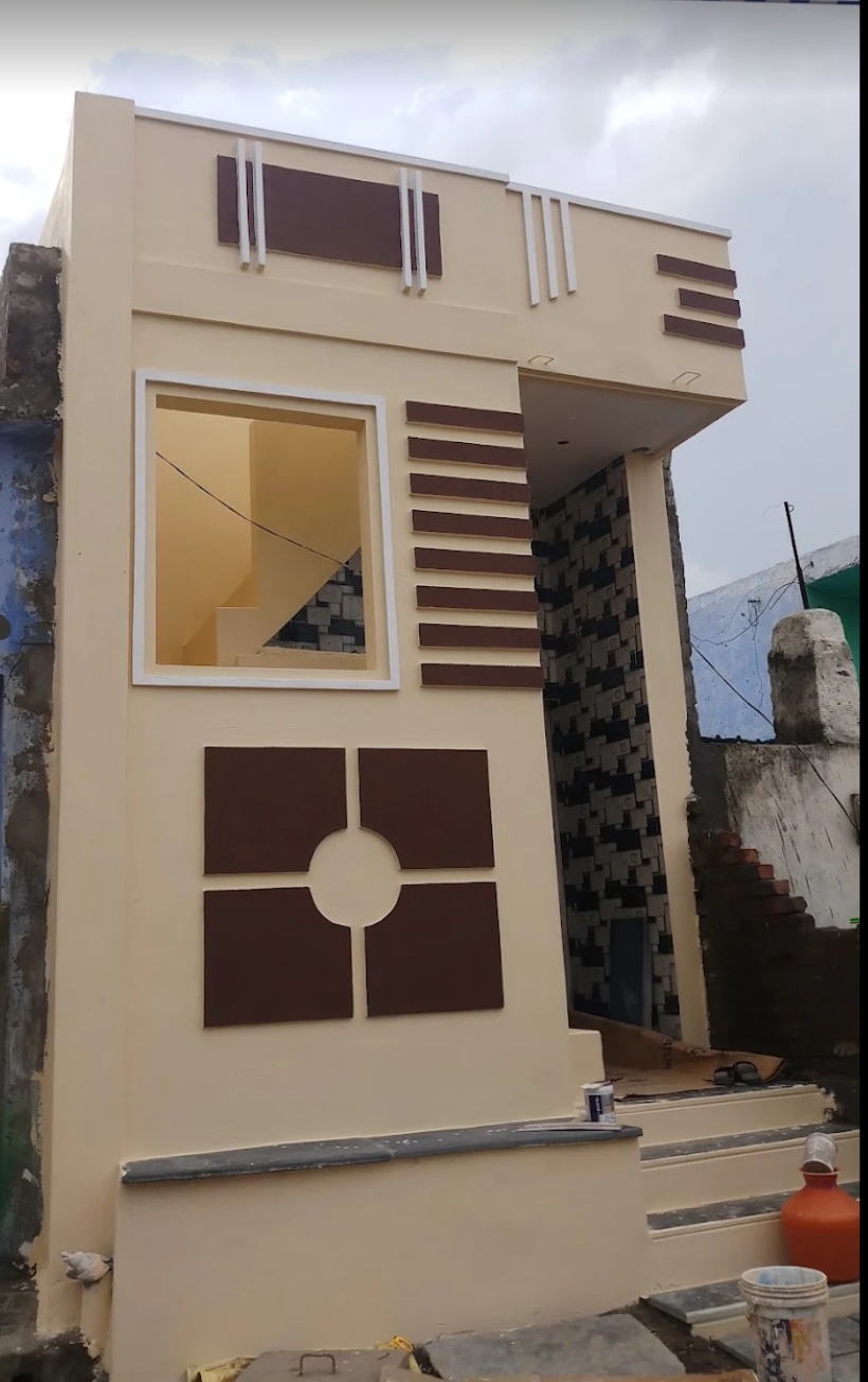 Cream and brown front elevation with decorative exterior paint details